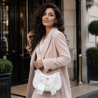 Sac à main perlé Célestine blanc porté en lifestyle à Paris