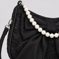Sac Célestine noir, détail du nœud et de la poignée perlée