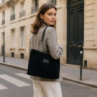 Sac à main Daphné Noir porté dans une rue parisienne